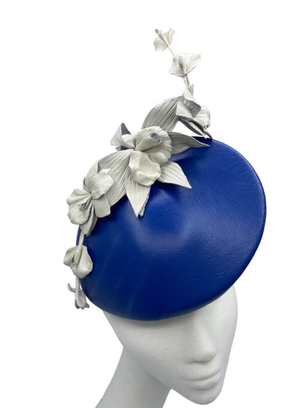 Blue leather teardrop with white leather flower detail.